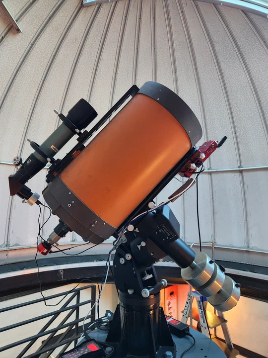 The UNSW Observatory telescope on its equatorial mount, with control computer, guide scope and imaging camera fitted.